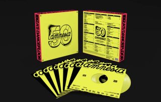 Bright yellow Amnesia 50th anniversary box set with vinyl records fanned in front against a black background, featuring bold pink edges and 'amnesia' branding.